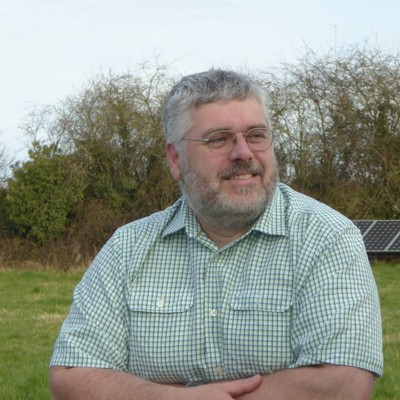 Tim leaning on a fence