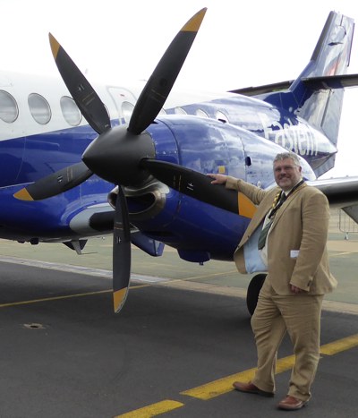 Me standing beside a small commercial aircraft